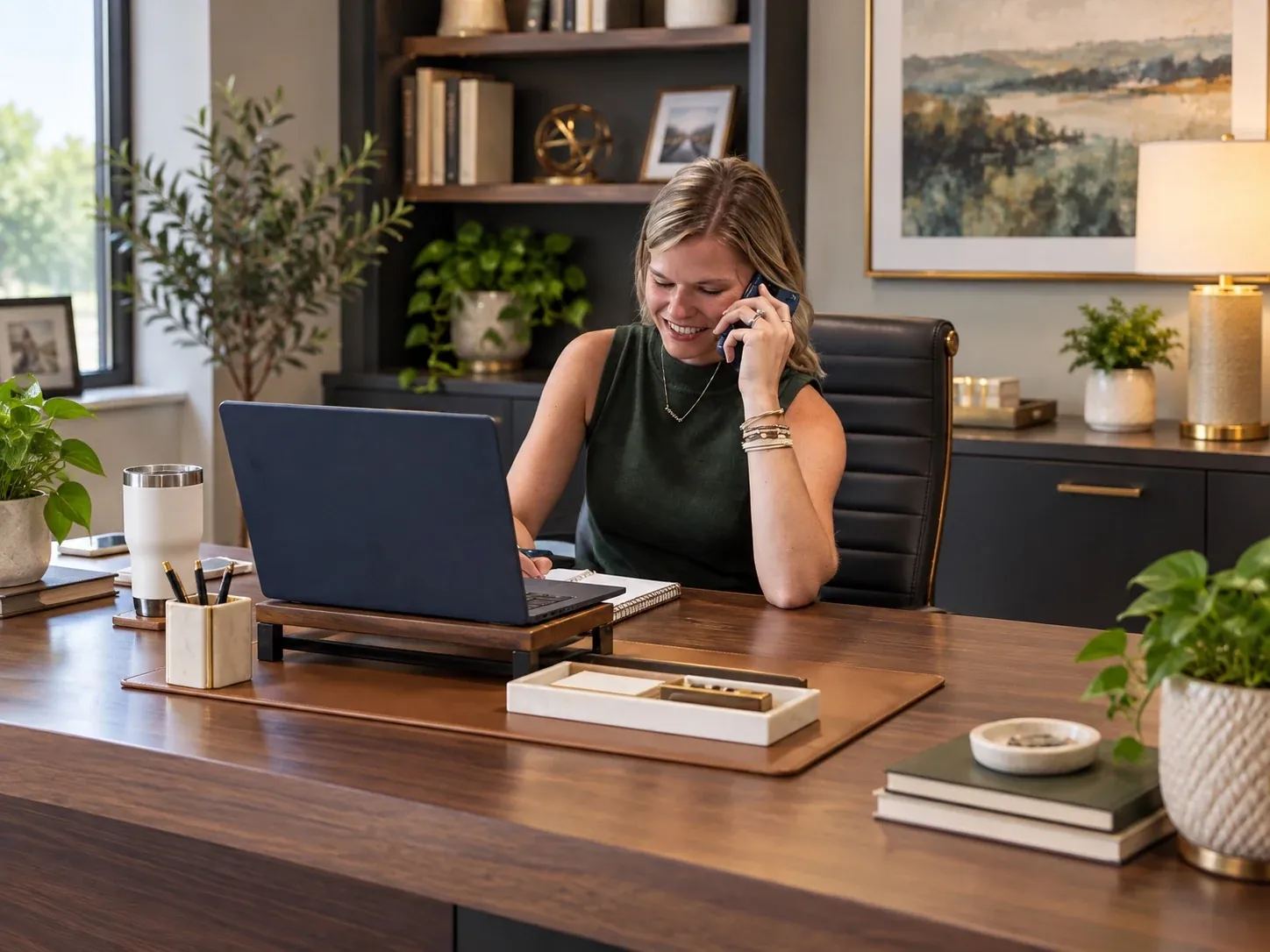 Lyndzie speaks with a customer by phone at her Heritage office desk.